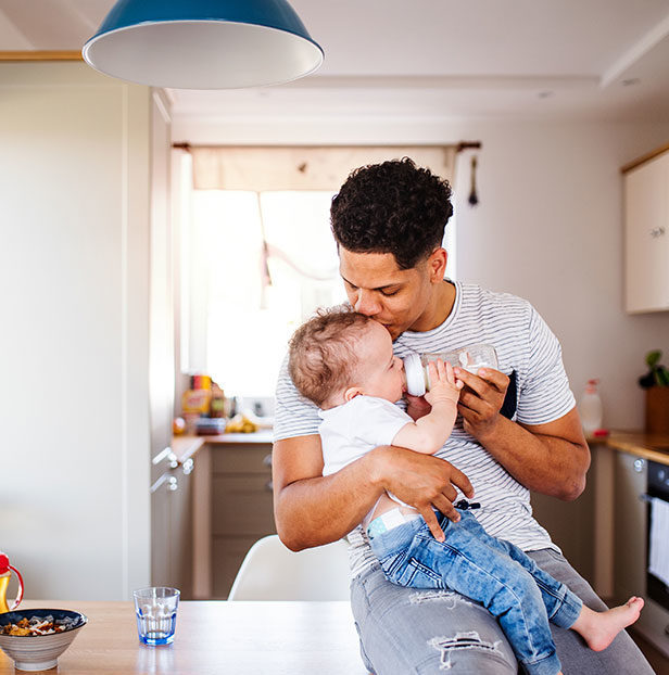 Man-feeding-baby-with-bottle