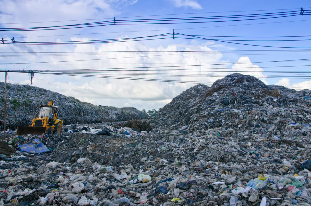 Plastic scrap in recycling center, Garbage truck unloading at the dump