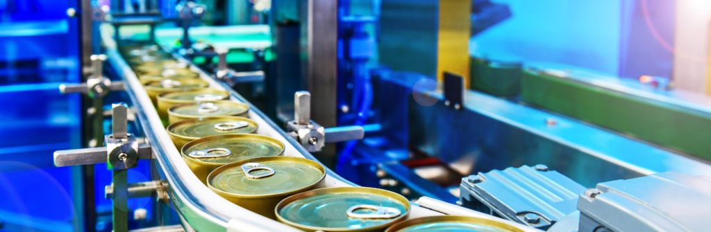 Canned food products on conveyor belt in distribution warehouse