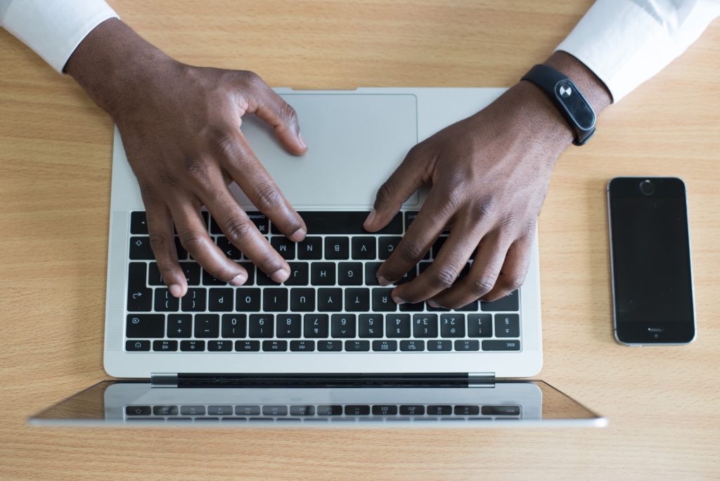 person typing on laptop