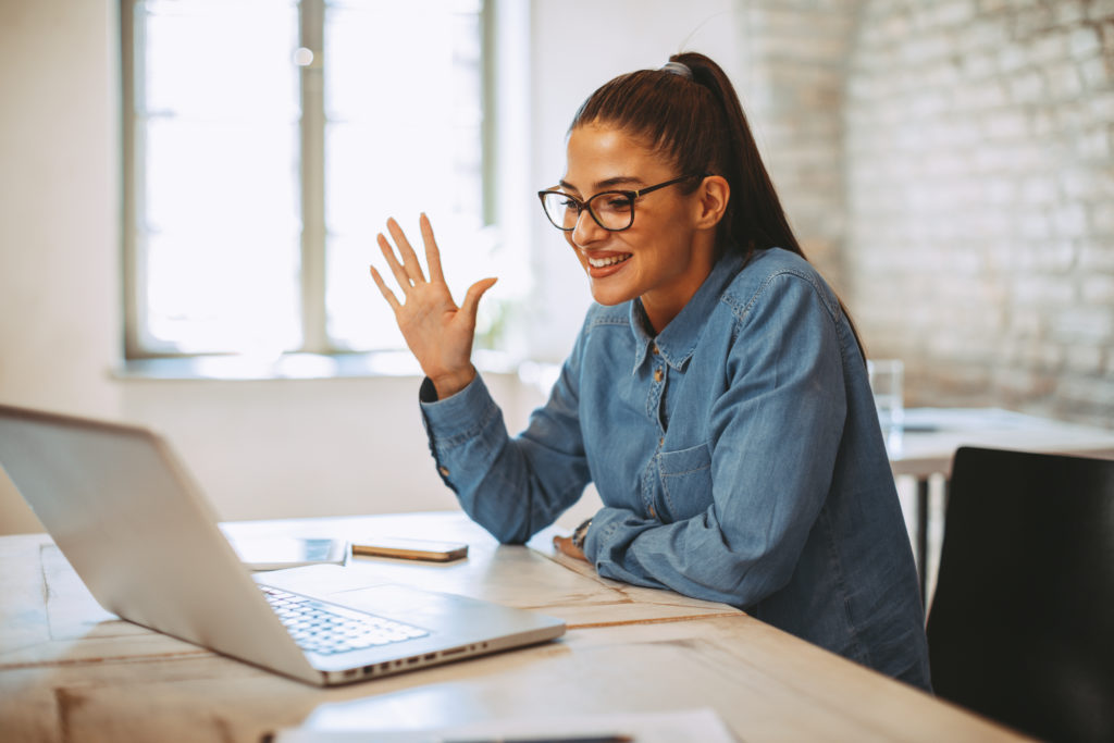 Young woman having video call via laptop in the office